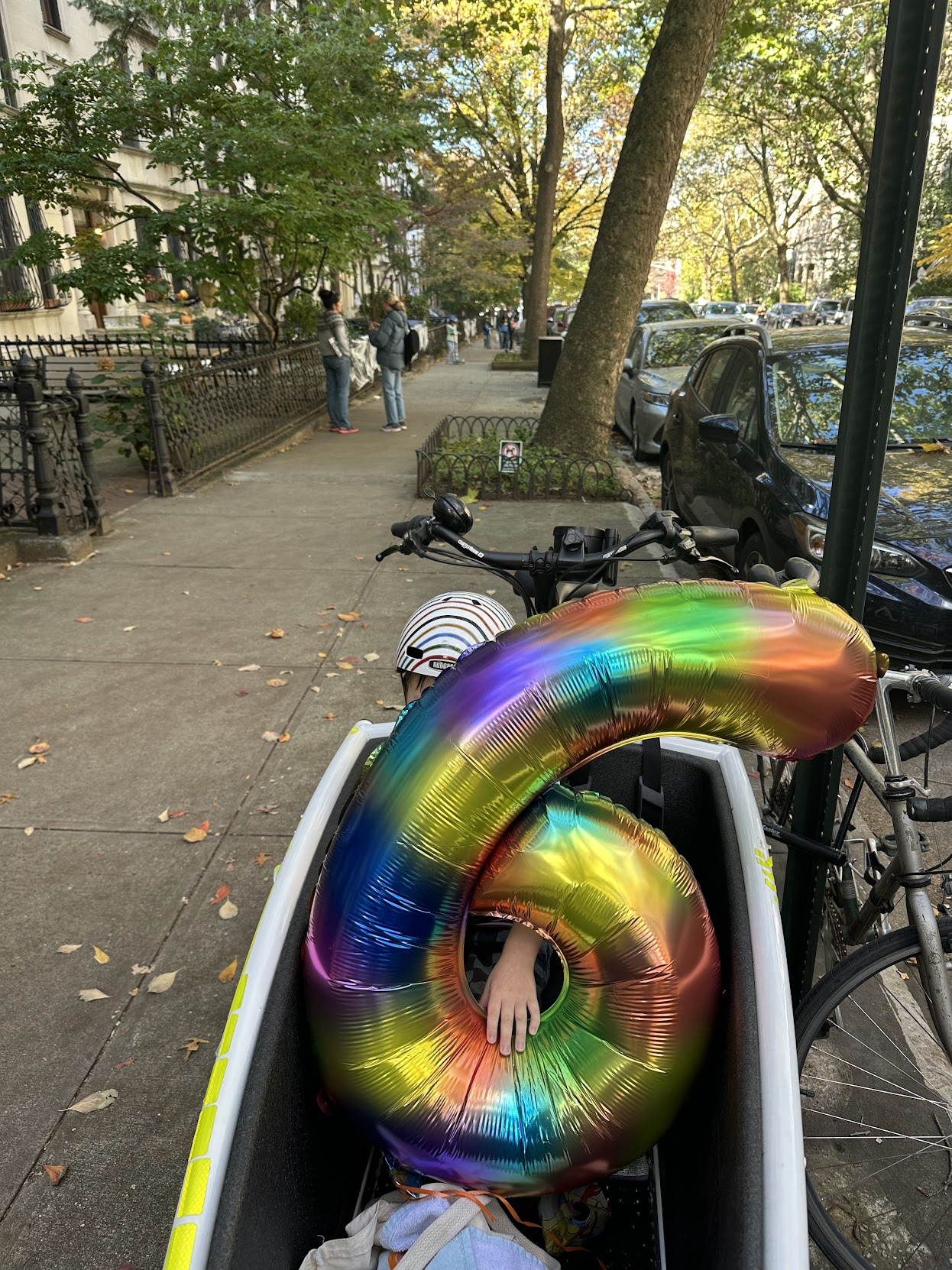 Rainbow balloon in the Urban Arrow cargo bucket on a Park Slope street